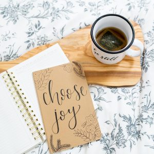 Choose Joy Journal and Be Still Mug during devotional time | by Lettering for Jesus | photo by The Modern Sojourner